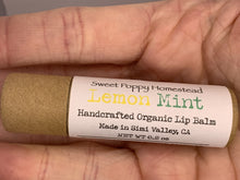Load image into Gallery viewer, Handcrafted lemon mint scented lip balm view in hand