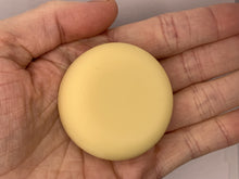 Load image into Gallery viewer, Lemon mint lotion bar in palm of hand
